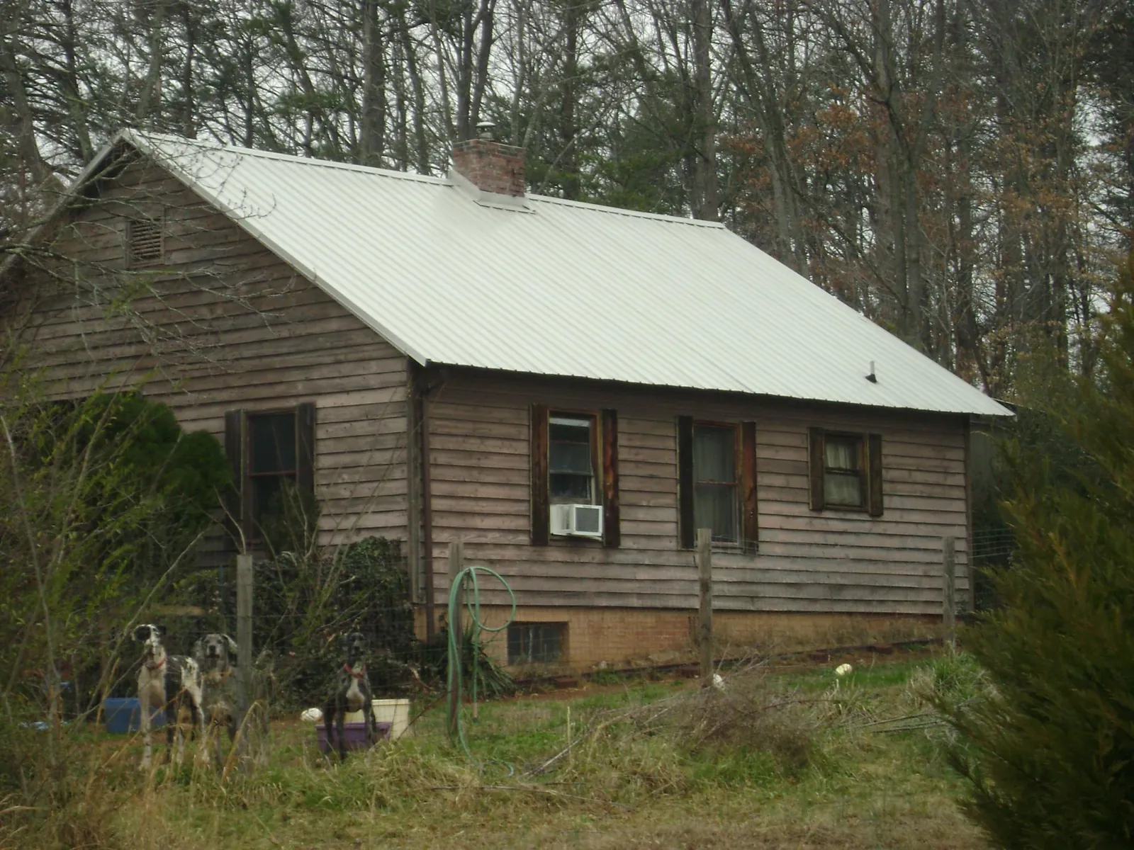 White metal roof on an old wood sided farmhouse, from a Metal Roof Installation job in Gay